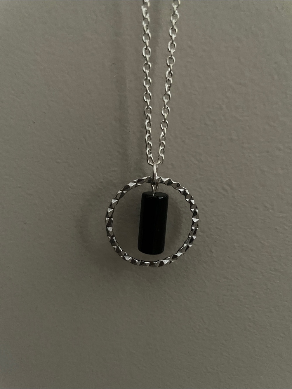 Hanging black cylinder gemstone necklace